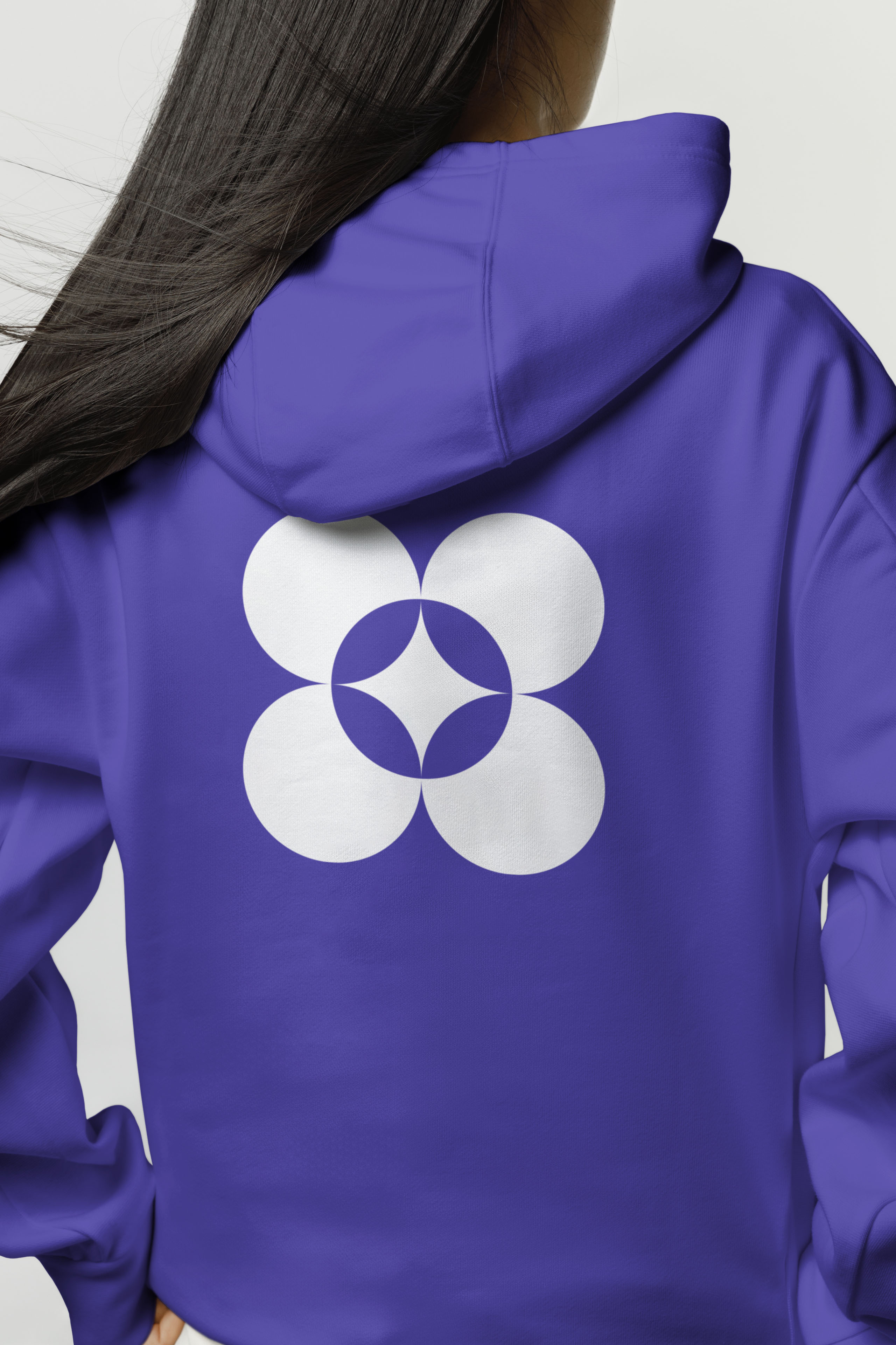 Back of an indigo hooded sweatshirt printed with Ava's four-petal logomark