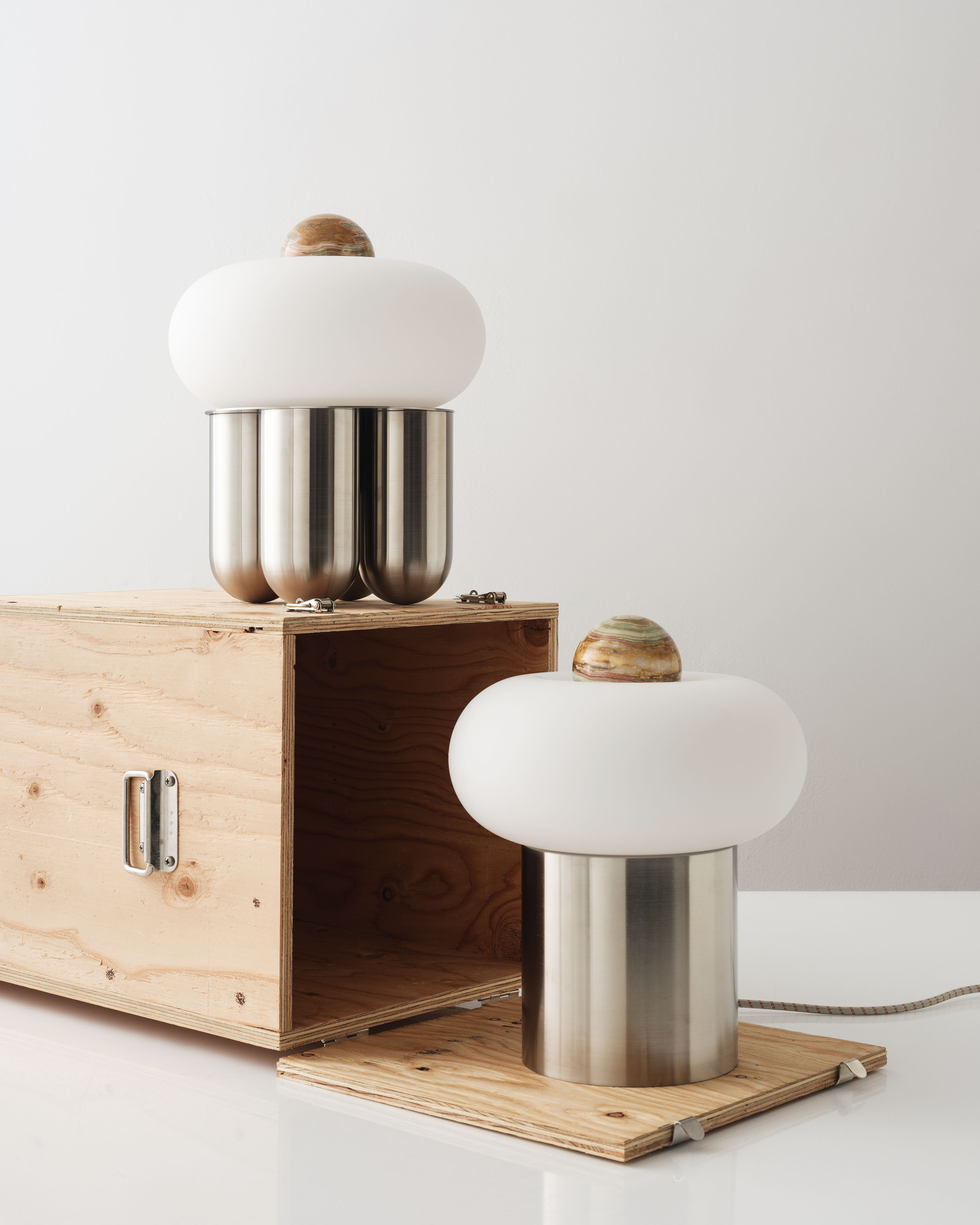 Detail of a dark storage crate with a “Capsula 01, Designed by Noiro Studio” product label and barcode